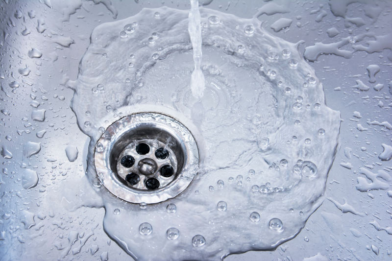 Clear water draining into a sink's drain - Boyd Plumbing