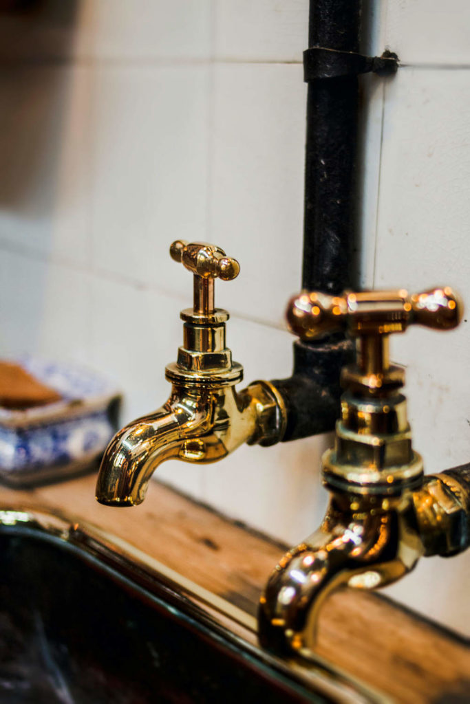 Brass faucets above a sink - Boyd Plumbing